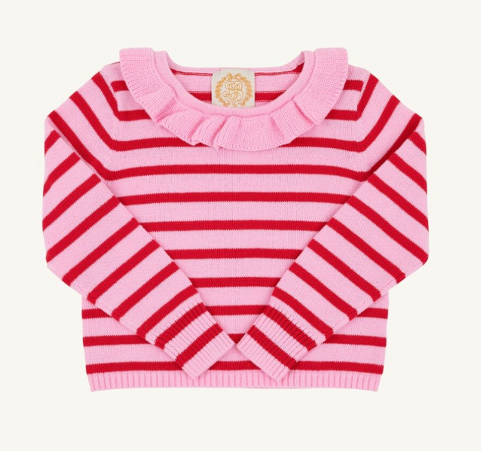 A pink and red striped knit sweater for toddlers, featuring a ruffled collar and long sleeves, laid flat against a light cream background.
