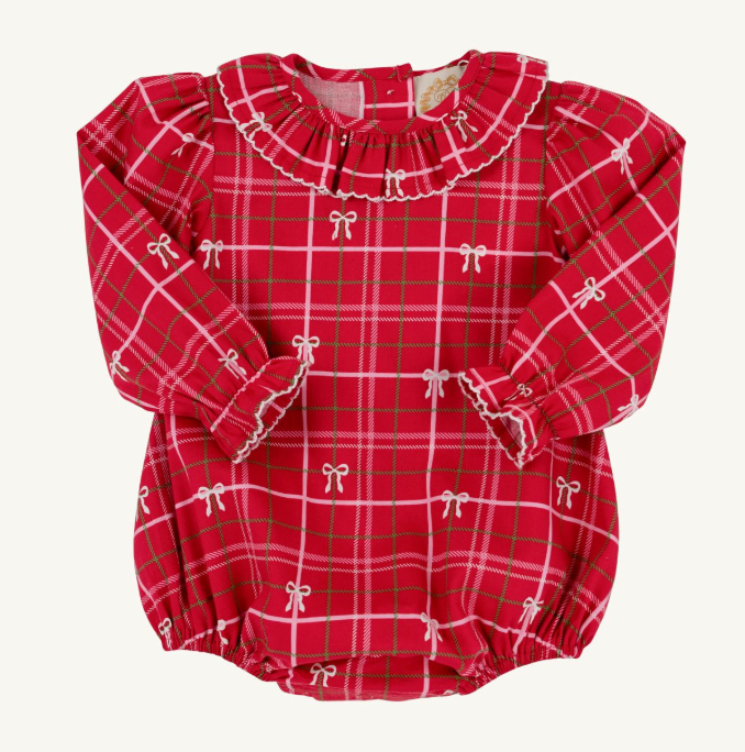 A red long-sleeve baby romper with a green and white plaid pattern, decorated with small white bow motifs and a ruffled collar, laid flat on a light background.
