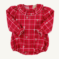 A red long-sleeve baby romper with a green and white plaid pattern, decorated with small white bow motifs and a ruffled collar, laid flat on a light background.