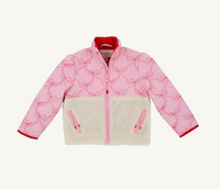 A pink quilted jacket with an allover bow pattern, a cream sherpa fleece lower panel, and red trim, shown flat against a light off-white background.