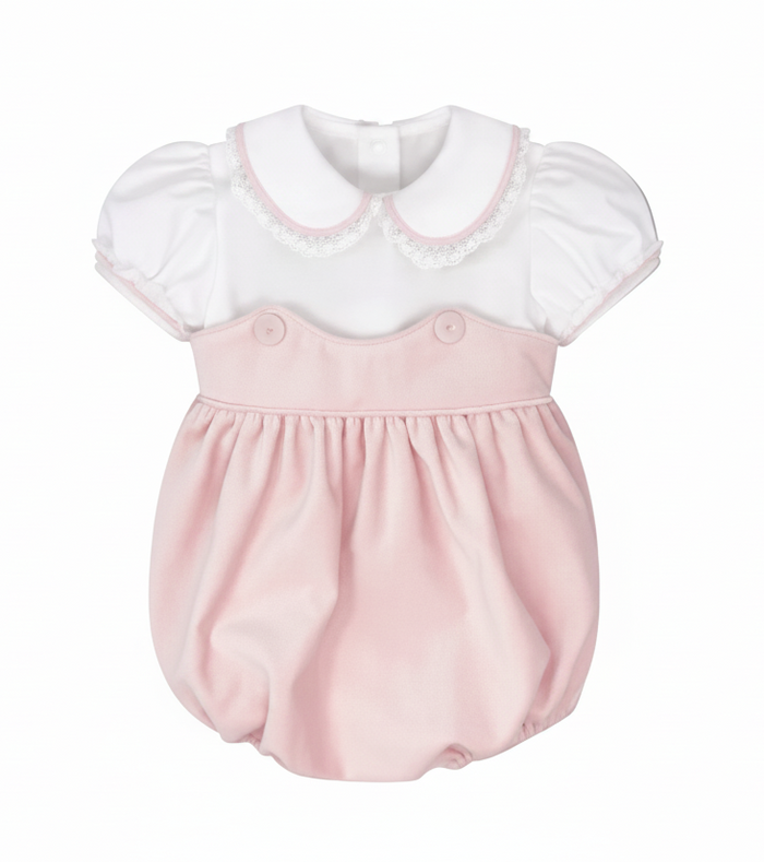 A baby bubble romper dress featuring a white short-sleeve top with a Peter Pan collar and lace trim, paired with a soft pink skirt and button details on the chest, shown against a solid gray background.