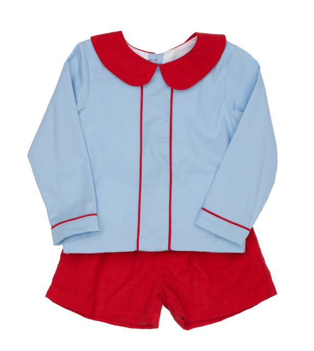 A two-piece children's outfit set featuring a light blue long-sleeve top with a contrasting red Peter Pan collar and red piping, paired with solid red shorts.