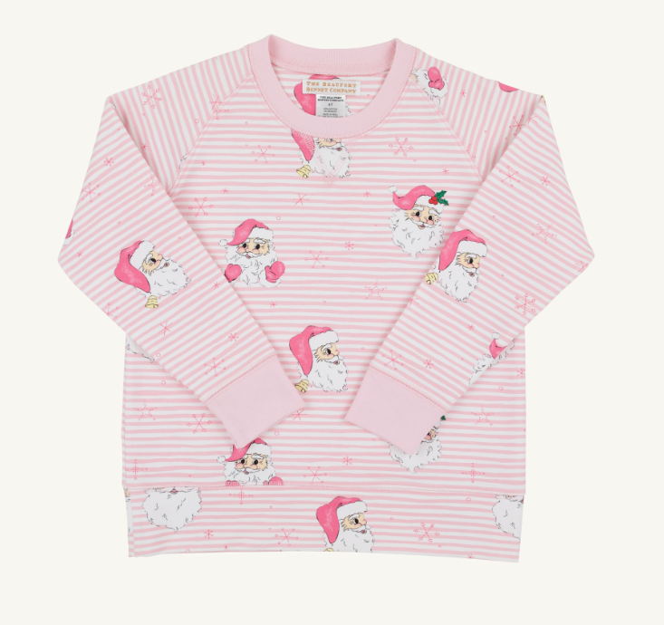 A pink and white striped long-sleeve pajama top with a repeating pattern of cartoon Santa Claus figures, photographed flat against a light cream background.