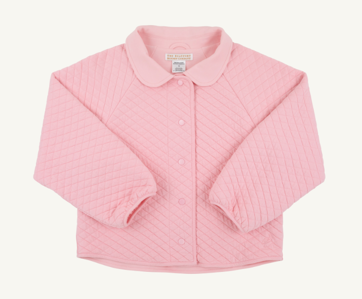 A pink quilted cardigan with a rounded Peter Pan collar and button-front closure, laid flat on a light cream background. The brand label inside the collar reads 'The Petites Paris'.