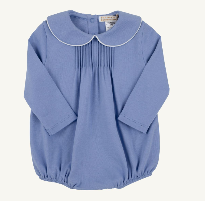 A baby boy long-sleeve smocked blouse in dusty blue, featuring a Peter Pan collar with white piping and a gathered elastic hem, shown flat on a light cream background.