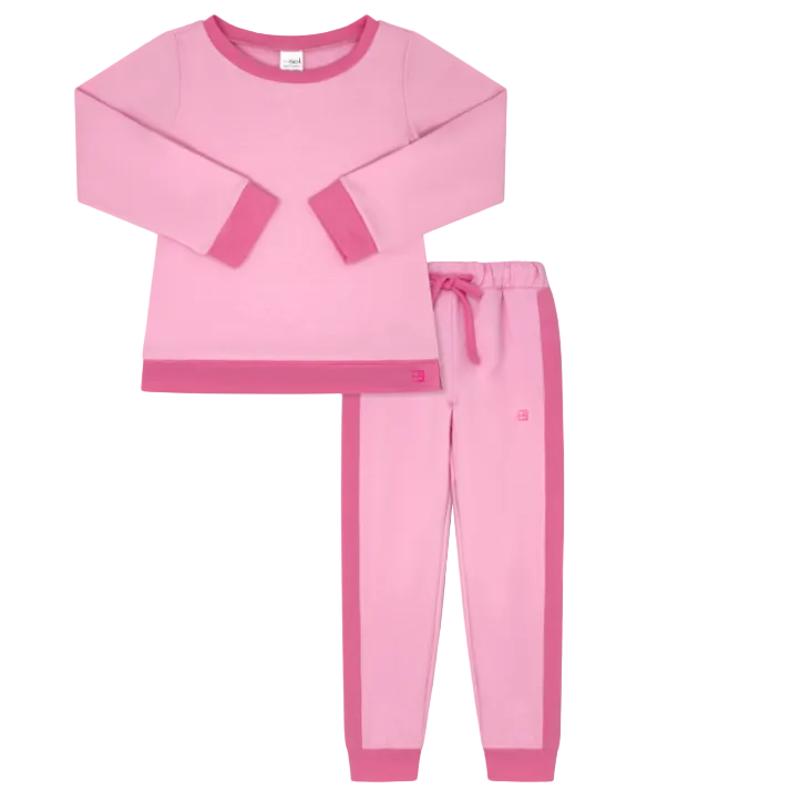 A two-piece children's pajama set in pink, featuring a long-sleeve top with contrasting pink cuffs and hem, and matching jogger pants with a pink side stripe and drawstring waist, displayed on a solid gray background.