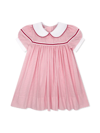 A pink gingham baby dress with a white Peter Pan collar, white short sleeves, and red and white smocked trim around the neckline.