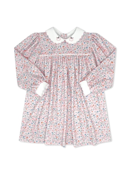 A long-sleeve baby dress with a delicate pink, blue, and white floral print, featuring a white Peter Pan collar with embroidered cartoon details and white cuffs.