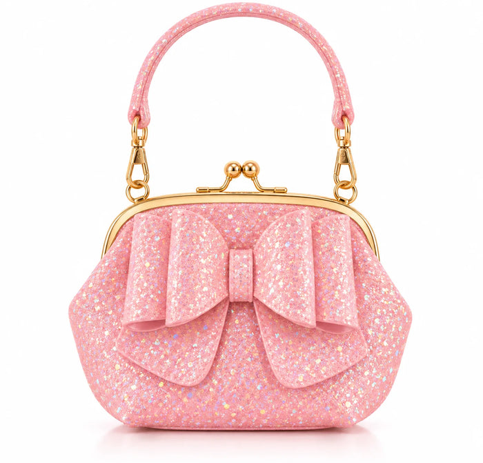 A pink glitter kiss-lock handbag with a large bow on the front, a top handle, and gold-tone metal hardware, shown on a clean white background.