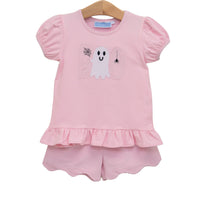 A toddler girl's two-piece pink outfit set featuring a short-sleeve top with a ghost and 'boo' applique design and a matching pink and white striped ruffled shorts set, hanging on a wooden hanger against a white background.