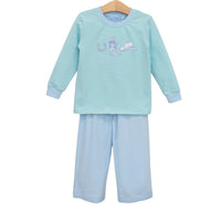 Children's pajama set with a striped shirt and pants on a hanger against a white background