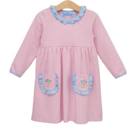Pink striped dress with blue accents on a hanger against a white background