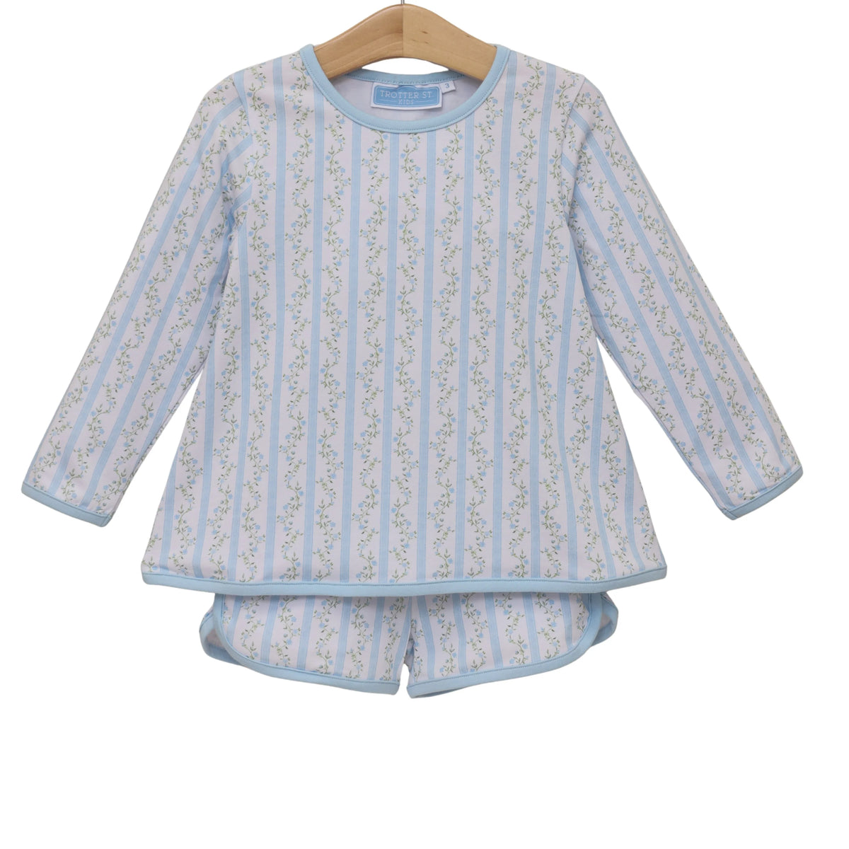 Children's blue and white striped pajama set on a hanger against a white background