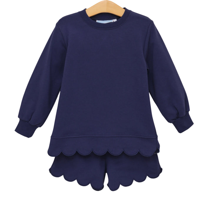 Navy blue dress with scalloped hem on a white background