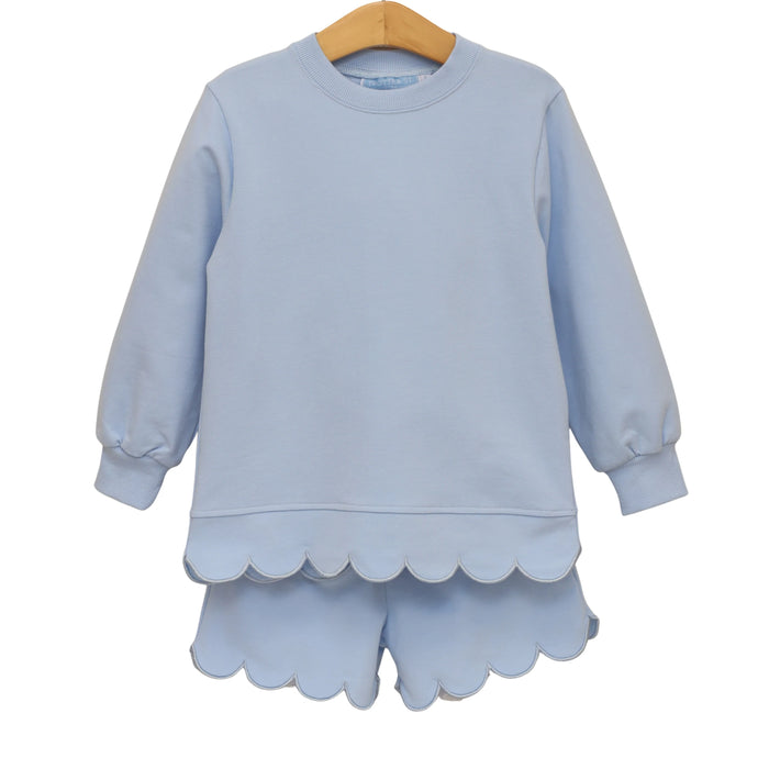 A light blue children's long-sleeve sweatshirt and matching shorts set hanging on a wooden hanger against a plain white background.