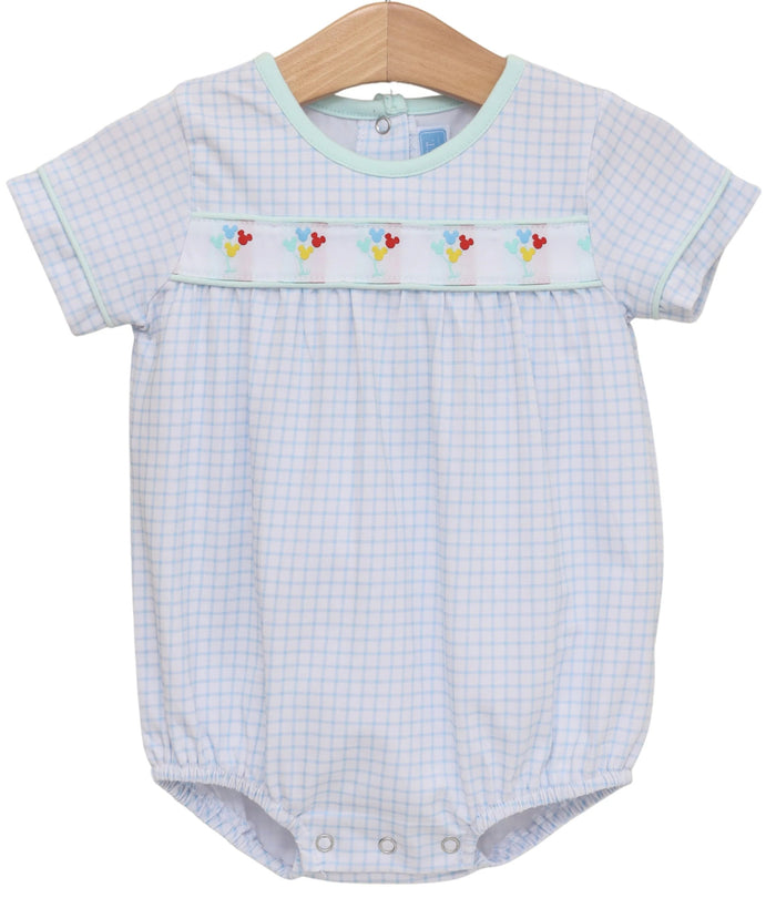 Baby romper with checkered pattern and embroidered details on a white background