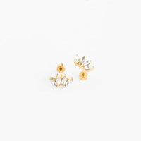 A pair of gold stud earrings with marquise-cut clear crystals, shown on a clean white background.