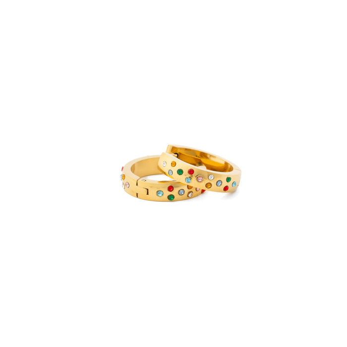 Gold rings with colorful gemstones on a white background