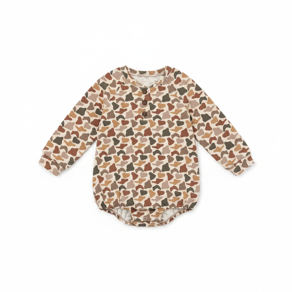 A long-sleeve baby romper with an all-over abstract organic pattern in shades of brown, beige, and dark gray, laid flat on a white background.