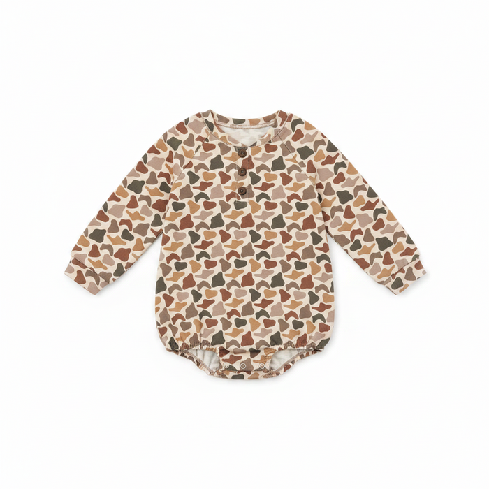 A long-sleeve baby romper with an all-over abstract organic pattern in shades of brown, beige, and dark gray, laid flat on a white background.