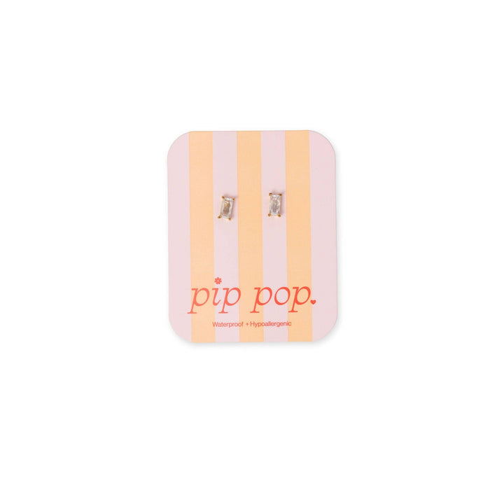 A pair of silver-toned hoop earrings displayed on a pink and peach striped backing card with the brand name 'pip pop.' printed in red at the bottom, set against a plain white background.