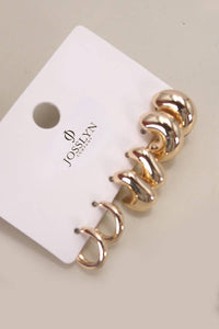 Gold spiral earrings on a Josievn branded card