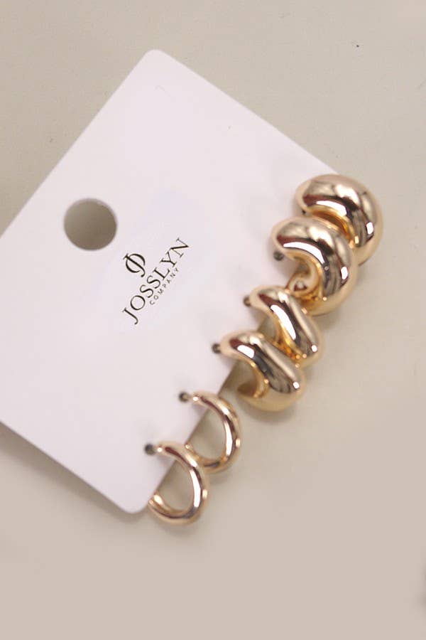 Gold spiral earrings on a Josievn branded card