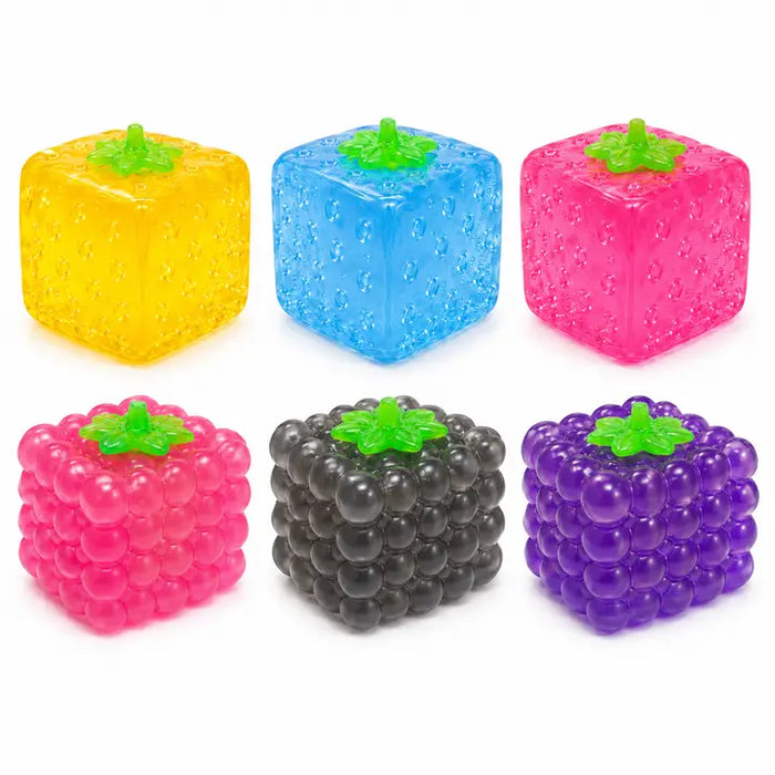 Six translucent fruit-shaped cube toys arranged in a 2-by-3 grid on a white background. The top row features yellow, blue, and pink strawberry-shaped cubes, while the bottom row shows pink raspberry, dark gray/black blackberry, and purple purple grape-shaped cubes.