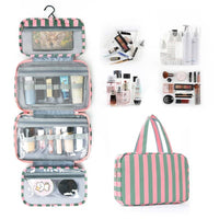 Striped cosmetic bag with makeup items displayed around it on a white background