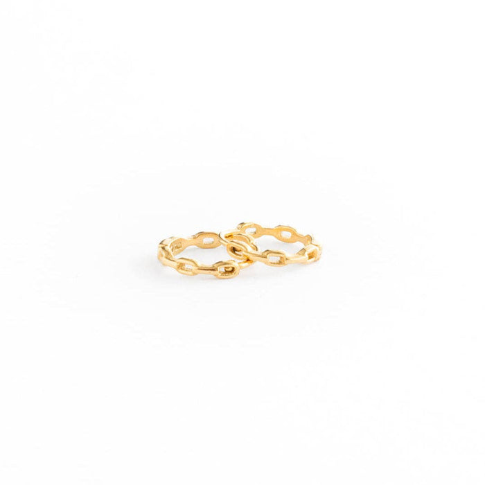 Two interlocking gold rings with a textured, open-link design, photographed on a seamless white background.