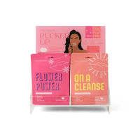 Display of pink skincare product boxes with text on a white background