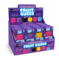 A purple retail display box filled with multiple small Sugar Squishers Fruit Cubes toy packages, shown on a clean white background. The display and boxes feature colorful fruit-cube graphics and text including 'Fruit Cubes' and 'Berry bubblegum flavor' and 'Berry seed texture'.