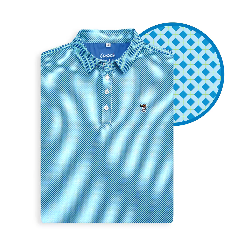 A folded light blue polo shirt with a small geometric pattern, shown next to a circular close-up of the fabric pattern. The brand name 'Cauda' is visible on the inner neck label.
