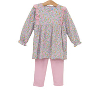 A toddler girl's two-piece outfit set featuring a long-sleeve floral print tunic top with pink ruffle details on the shoulders and sleeves, paired with solid light pink leggings, displayed on a wooden hanger against a white background.