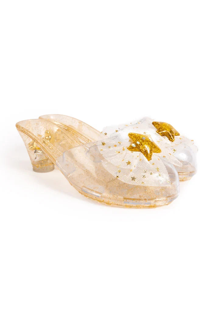 Clear clogs with gold floral design on a white background