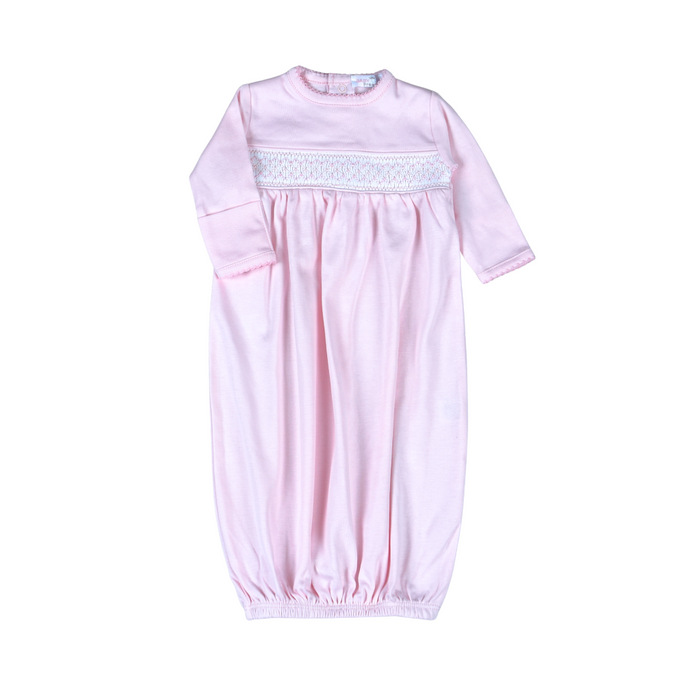 A light pink baby sleep sack with long sleeves, a crew neck, and a decorative white embroidered band across the chest, shown flat on a white background.