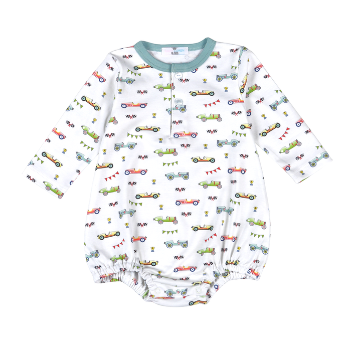 A white long-sleeve baby romper with an all-over colorful vintage race car print, featuring a mint green ribbed collar and elasticized leg cuffs.