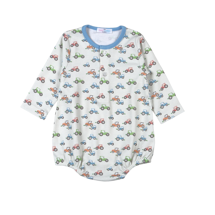 A baby long-sleeve romper with an all-over tractor print on a white background, featuring a light blue collar and snap-button closure at the neckline.