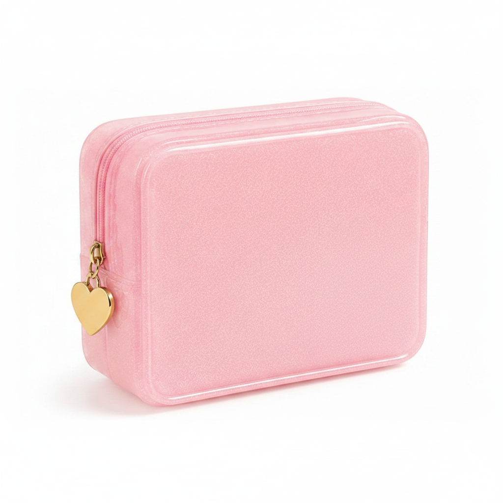 A small rectangular pink zippered case with rounded corners, a textured finish, and a gold heart-shaped zipper pull, shown on a clean white background.