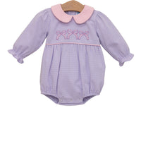Purple striped baby romper with pink collar on a white background
