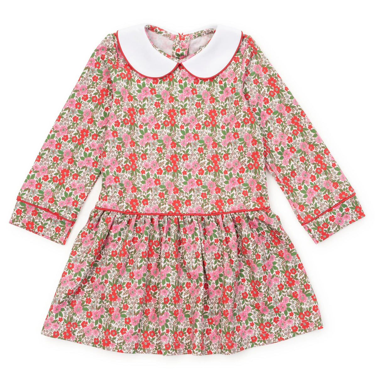 A long-sleeve children's dress with a pink and red floral print on a light beige background, featuring a contrasting white Peter Pan collar and red piping details.