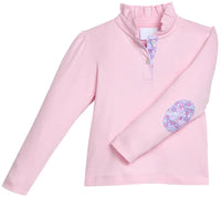 A pink long-sleeve mock neck top with a buttoned placket and a floral patch on the left elbow, shown on a plain white background.
