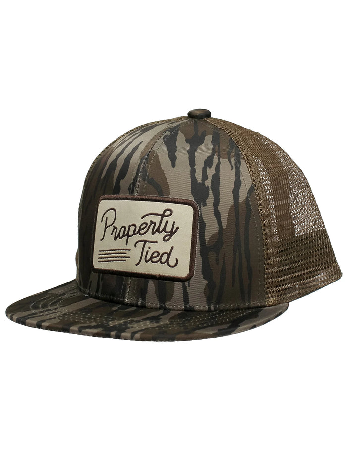 Camouflage trucker hat with 'Properly Tied' logo on a white background