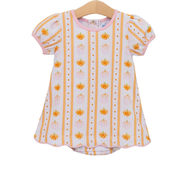 A toddler girl's short-sleeve top on a wooden hanger, featuring a white base with vertical orange stripes, small orange pumpkins, and tiny orange dots, finished with a pink collar and trim.