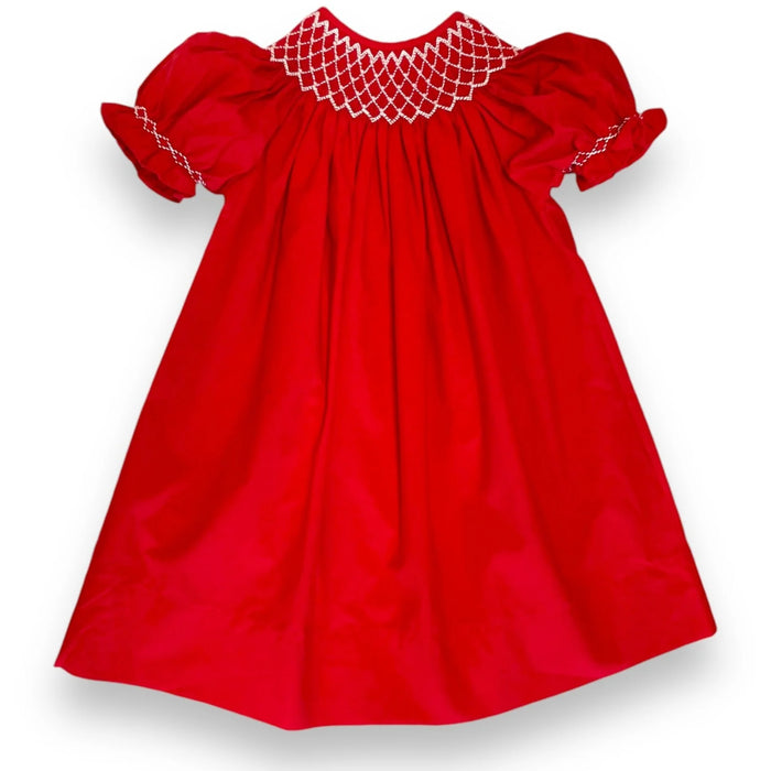 A bright red baby dress with short puff sleeves and white smocked detailing around the neckline and sleeve cuffs, shown against a plain white background.
