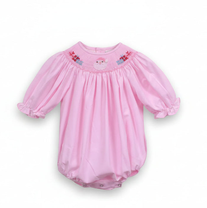 A baby girl's pink long-sleeve romper with puff sleeves, featuring a smocked yoke with a small embroidered Santa face and gift details, hanging on a white hanger against a white background.